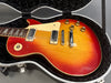 Vintage sunburst electric guitar with dual pickups and chrome bridge in black plush case