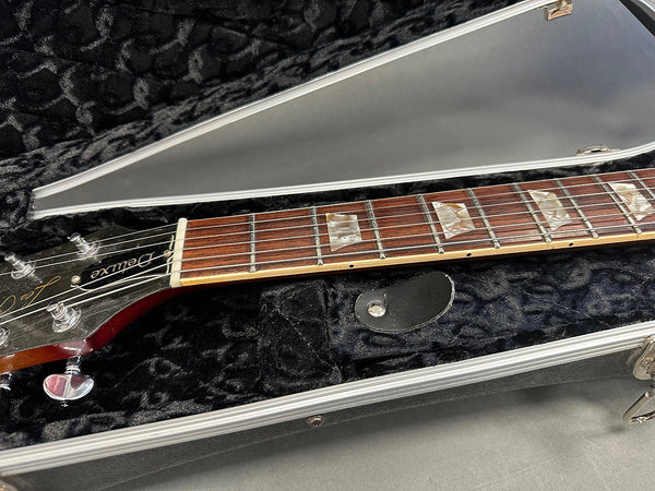 Close-up of Gibson Les Paul Deluxe guitar neck with pearl block inlays in black plush hard case at Coffee House Guitars