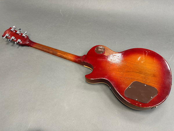 Vintage sunburst electric guitar back with maple neck and chrome tuning pegs on gray background