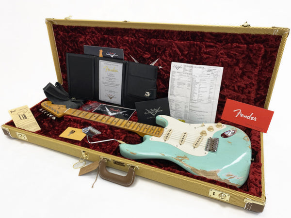 Fender Custom Shop vintage style electric guitar in aged seafoam green finish with maple neck, displayed in tweed hardshell case with red velvet interior, including Fender Certificate of Authenticity, owner’s manual, strap, tremolo arm, key, and other official Fender documentation.