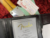 Fender Certificate of Authenticity for 57 Stratocaster Hvy Relic model with serial number R101238 dated 09/30/2019 showing Fender Custom Shop paperwork on a guitar with a green body and wood neck on a red velvet background