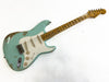 Fender Stratocaster electric guitar in relic seafoam green finish with maple neck and vintage-style pickups against white background
