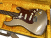 Vintage silver electric guitar with tortoiseshell pickguard and rosewood fretboard in yellow plush-lined hard case