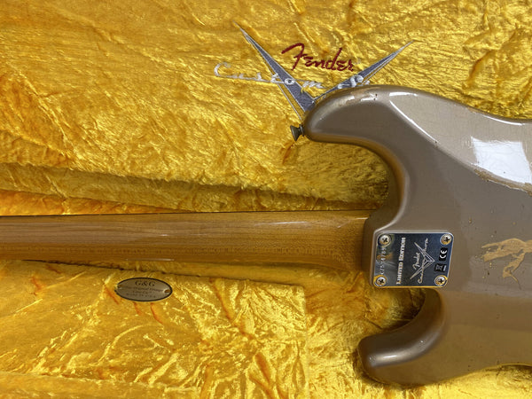 Fender Custom Shop Limited Edition electric guitar neck and body back with visible wear, resting in a yellow plush Fender guitar case interior