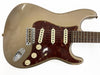 Vintage Fender Stratocaster electric guitar with relic Gold finish, tortoiseshell pickguard, three single-coil pickups, and rosewood fretboard
