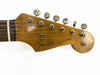 Close-up of vintage Fender Stratocaster guitar headstock with six tuning pegs and original contour body logo on natural wood finish