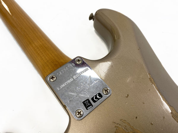 Close-up of the neck plate on a limited edition Fender Custom Shop electric guitar showing serial number and CE mark on a worn beige guitar body
