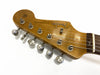 Close-up of vintage Fender Stratocaster guitar headstock with six tuning pegs and rosewood fretboard section on white background