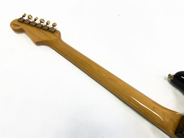 Glossy maple neck of electric guitar with vintage tuning pegs on white background showing headstock shape