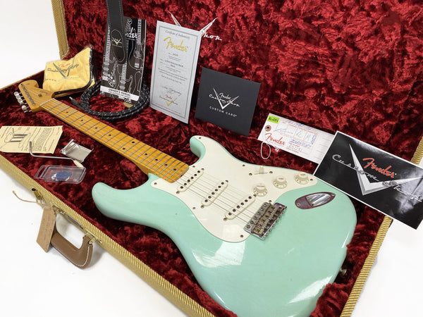 Fender Custom Shop Surf Green Stratocaster electric guitar with maple neck in open tweed hardshell case with certificate of authenticity, owner's manual, strap, tremolo arm, and Fender Custom Care booklet on red plush interior