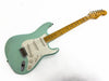 Fender Stratocaster electric guitar with seafoam green body, white pickguard, and maple neck on white background