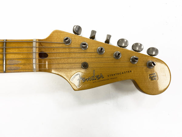 Vintage Fender Stratocaster guitar headstock with original tuning pegs and logo on maple wood neck