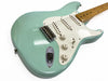 Light blue vintage electric guitar with white pickguard and maple neck, close-up of body and controls on white background