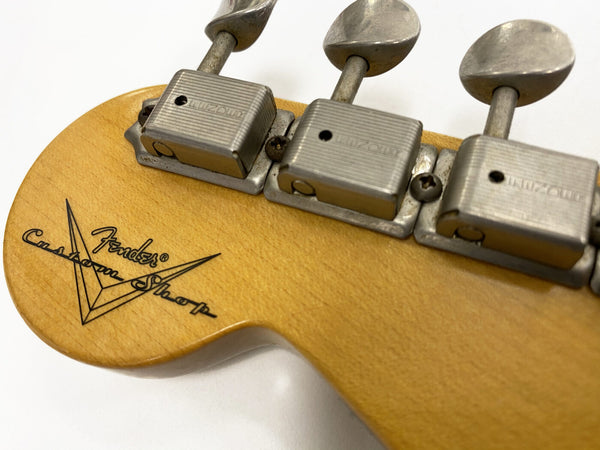 Close-up of Fender Custom Shop vintage guitar headstock with licensed Kluson tuning pegs and clear logo on natural wood finish