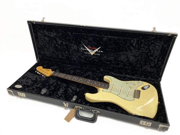 Vintage Fender Stratocaster electric guitar in cream finish with white pickguard and rosewood fretboard, displayed inside black Fender Custom Shop Limited Edition hard case with plush interior lining.