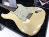 Vintage Fender Stratocaster electric guitar with aged cream finish and three single-coil pickups in black velvet-lined hard case