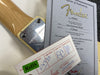 Close-up of Fender 1964 Stratocaster Relic Limited Edition guitar neck plate and certificate of authenticity with serial number CZ509595 and RoHS compliance card.