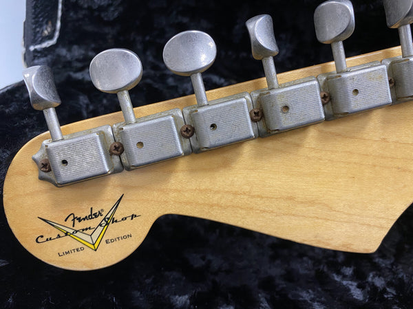 Close-up of Fender Custom Shop Limited Edition guitar headstock with vintage tuning pegs and natural wood finish on black background