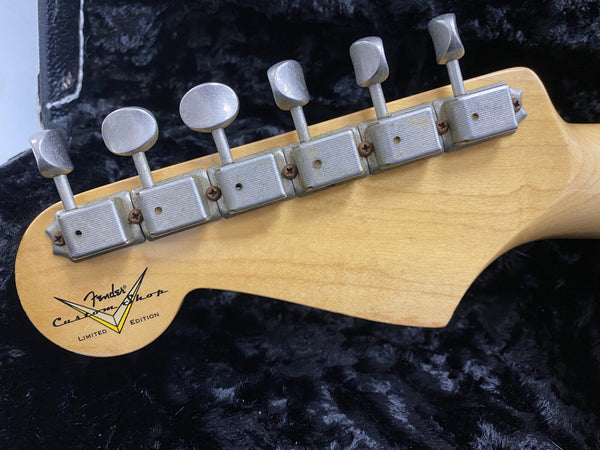 Close-up of vintage Fender Custom Shop limited edition electric guitar headstock showing tuning pegs and maple wood grain in black guitar case interior