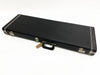 Black rectangular guitar hard case with silver metal latches and handle, white stitching detail, and a small brown tag attached to the handle.