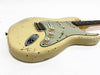 Vintage cream electric guitar with relic finish, three single-coil pickups, and cream control knobs on white background