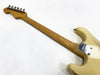 Back view of vintage Fender Stratocaster electric guitar neck and body with maple fretboard and cream finish showing neck plate and tuning pegs