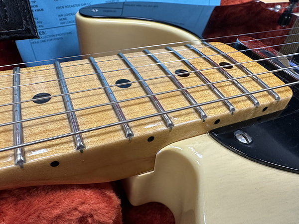 Close-up of vintage electric guitar maple fretboard with dot inlays and metal frets, showing guitar neck joint and strings at Coffee House Guitars