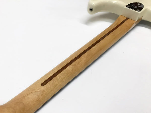 Maple guitar neck with a walnut skunk stripe and white guitar body visible on a plain white background