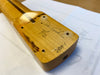 Close-up of signed vintage guitar neck heel with handwritten serial number and markings on maple wood at Coffee House Guitars