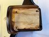 Close-up of electric guitar neck pocket showing wood grain and screw holes with black and brown finish edges