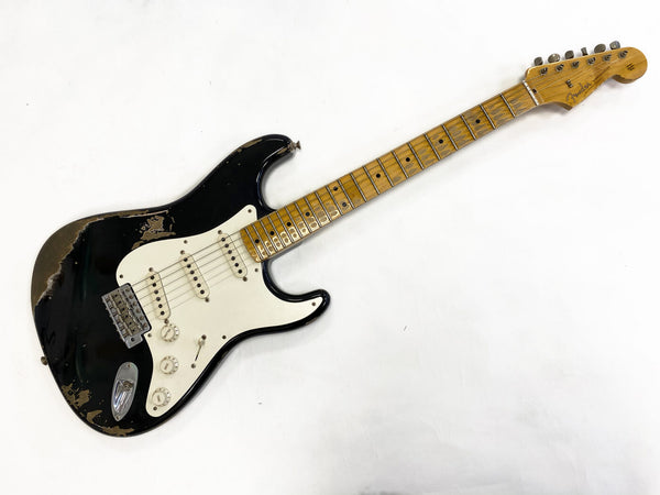 Fender Stratocaster electric guitar with black relic finish and maple neck on white background