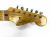 Vintage Fender Stratocaster maple guitar headstock with six tuning pegs and original contour body decal on white background
