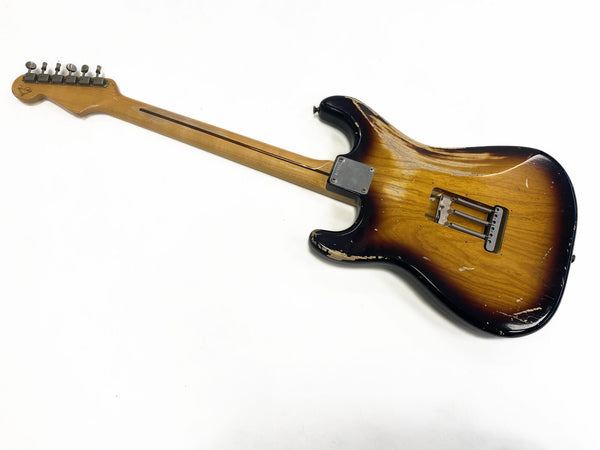 Vintage sunburst electric guitar with maple neck and visible wear showing on the body, back view on white background