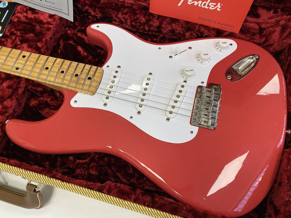 Fender Stratocaster electric guitar in red finish with white pickguard and maple neck inside a plush red lined case with Fender owner's manual visible