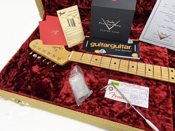 Fender Stratocaster guitar neck with maple fretboard inside a red plush-lined tweed case, surrounded by Fender Custom Shop care cards, warranty documents, tremolo spring instructions, a guitar receipt, and a tremolo arm.
