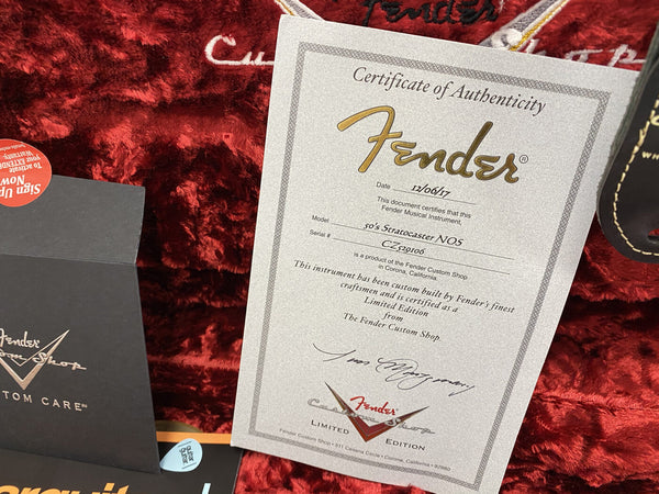 Fender Custom Shop Certificate of Authenticity for 50's Stratocaster NOS guitar dated 12/06/17 with serial number CZ520106 on red velvet guitar case lining with Fender Custom Shop envelope and warranty materials