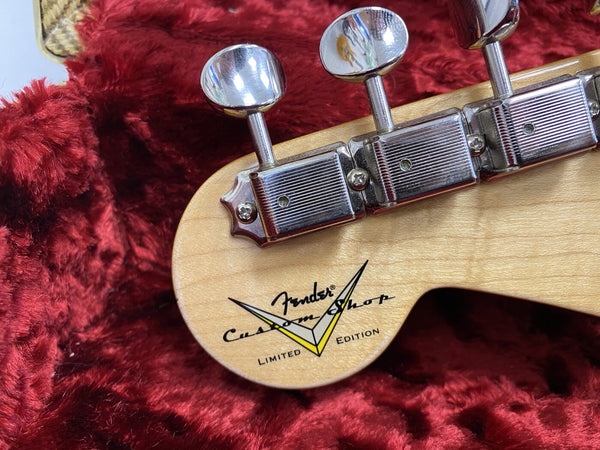 Close-up of Fender Custom Shop Limited Edition guitar headstock with tuning pegs on red plush background