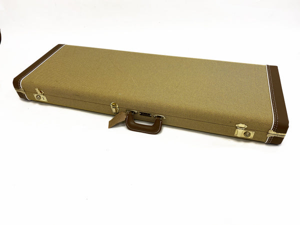 Vintage style tweed rectangular guitar case with brown leather handle and corner reinforcements on white background