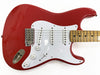 Red electric guitar body with white pickguard, three single-coil pickups, volume and tone control knobs, maple neck with dot inlays, and chrome bridge hardware on white background