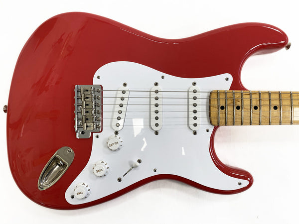 Red electric guitar body with white pickguard, three single-coil pickups, volume and tone control knobs, maple neck with dot inlays, and chrome bridge hardware on white background