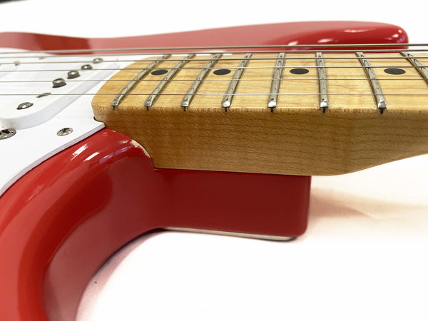 Close-up view of red electric guitar neck joint with maple fretboard and metal frets at Coffee House Guitars