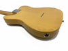 Close-up rear view of natural wood finished electric guitar body with string ferrules and input jack on white background