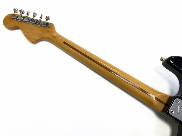 Maple guitar neck with rosewood skunk stripe and chrome tuning pegs on electric guitar against white background