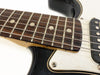 Close-up of electric guitar fretboard with dot inlays, metal frets, and steel strings, featuring black body and white pickguard with visible screw for Coffee House Guitars product listing.