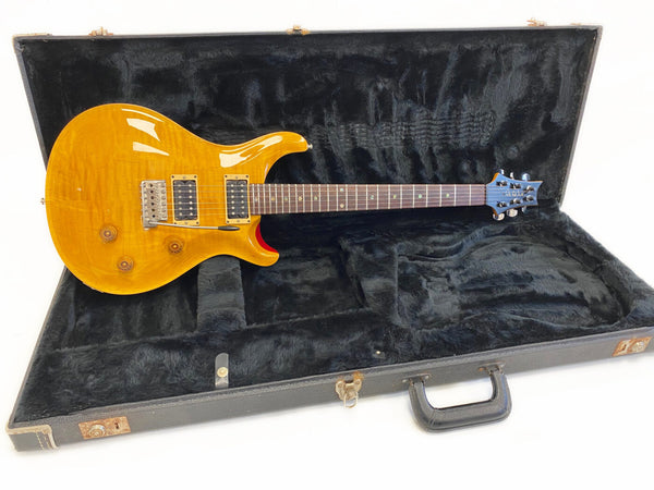PRS electric guitar with honey burst finish, dual humbucker pickups, and rosewood fretboard in open black plush hard case