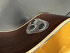 Close-up of acoustic guitar control panel with TransAcoustic effects including reverb, chorus, and line out volume knobs on wood grain finish guitar body