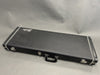 Black vintage Fender guitar hard case with silver latches and handle on gray background