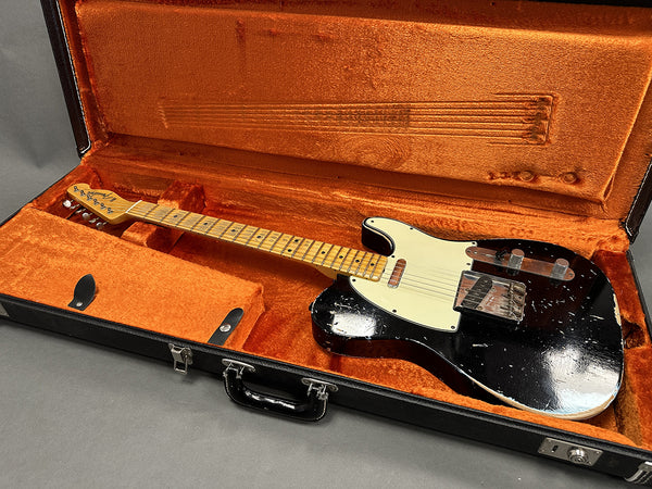 Vintage black Fender Telecaster electric guitar with maple neck and white pickguard in open orange plush-lined black hardshell guitar case