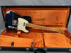 Vintage Fender Telecaster electric guitar with black body, maple neck, and white pickguard in orange-lined black hardshell case