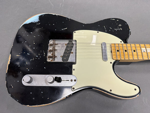 Black relic finish electric guitar with maple neck, white pickguard, and vintage bridge, displayed on gray background